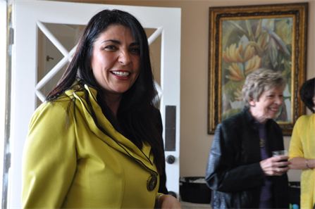 Ellie Ortiz waits to greet guests as they arrive for the Grand Opening Celebration